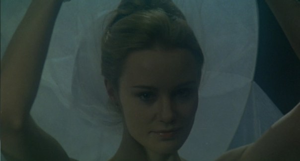 Death raises her veil.